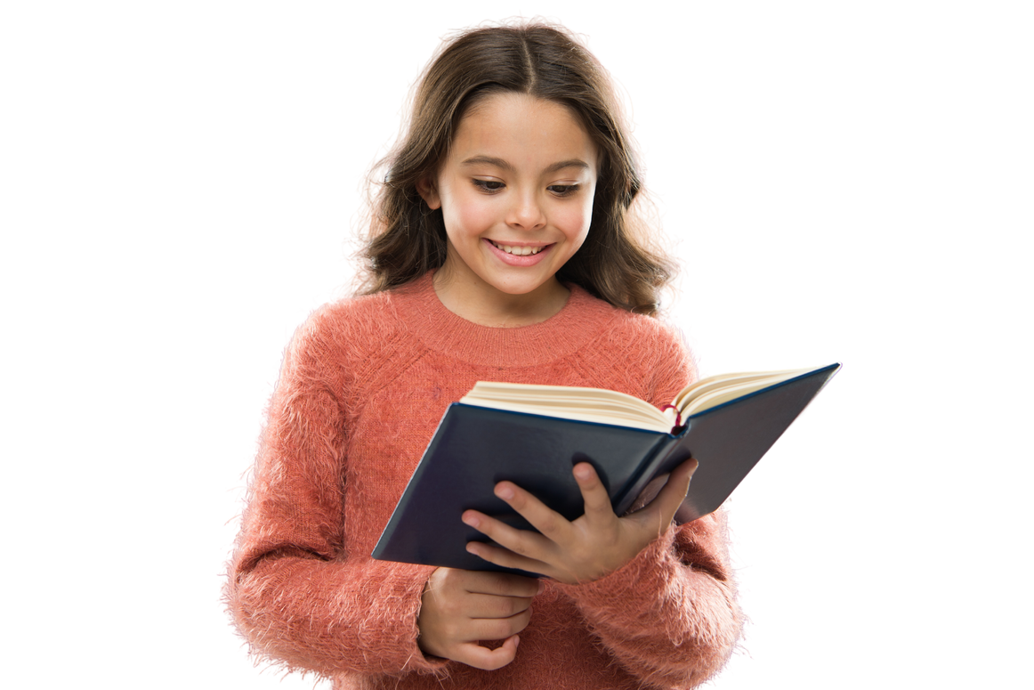 a child smiling while reading an open book